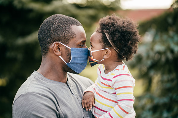 Dad and daughter in masks