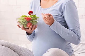 A woman eating a salad