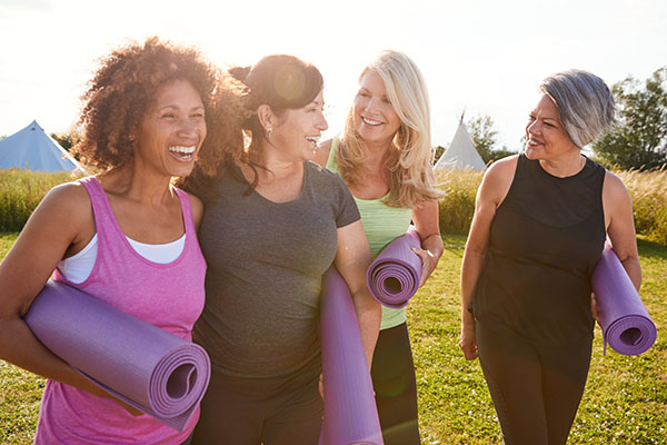 women with yoga mats