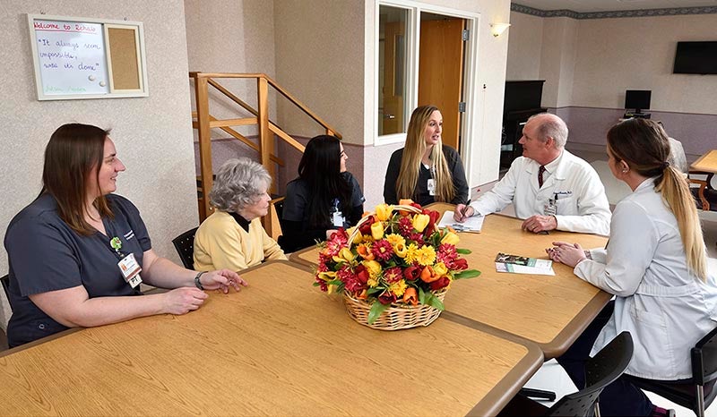 Faculty gathered together in the employee dining room